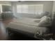 Bright bedroom with blinds, TV, dresser and a comfortable queen bed at 14305 Tennyson Dr, Hudson, FL 34667