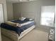Cozy bedroom showing a bed and window with neutral wall color at 14305 Tennyson Dr, Hudson, FL 34667