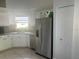 Compact kitchen featuring stainless steel appliances, ample counter space, and white cabinetry at 14305 Tennyson Dr, Hudson, FL 34667