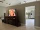 Bright living room showcasing access to the kitchen, a large television and neutral paint at 14305 Tennyson Dr, Hudson, FL 34667