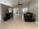 Large living room with modern furniture, a ceiling fan, and a doorway leading to other rooms at 14305 Tennyson Dr, Hudson, FL 34667
