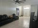 Spacious living room with tile flooring, a ceiling fan, and comfortable leather furniture at 14305 Tennyson Dr, Hudson, FL 34667