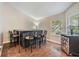 Bar area with seating, hardwood floors, a mini refrigerator and a window at 16808 Woburn Ln, Lutz, FL 33549