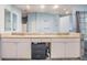 Stylish bathroom with double granite vanity, large mirror, and ample storage space at 16808 Woburn Ln, Lutz, FL 33549
