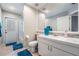 Well-lit bathroom features a shower/tub combination and vanity with sink at 16808 Woburn Ln, Lutz, FL 33549