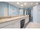 Elegant bathroom featuring double vanity, granite counters, and decorative lighting at 16808 Woburn Ln, Lutz, FL 33549