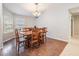 Dining room with hardwood floors, a window, and seating for six at 16808 Woburn Ln, Lutz, FL 33549