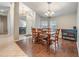 Inviting dining room boasts hardwood floors, stylish chandelier, and natural light from the window at 16808 Woburn Ln, Lutz, FL 33549