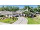 Charming single-story home with a well-manicured lawn and a circular driveway, exuding curb appeal at 16808 Woburn Ln, Lutz, FL 33549