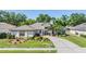 Charming single-story home with a well-manicured lawn and a circular driveway, exuding curb appeal at 16808 Woburn Ln, Lutz, FL 33549