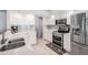 Bright kitchen with white cabinets, stainless steel appliances, and stylish backsplash at 16808 Woburn Ln, Lutz, FL 33549