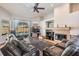 Living room with fireplace, hardwood floors, and a view of the backyard pool at 16808 Woburn Ln, Lutz, FL 33549