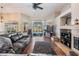 Living room with fireplace, hardwood floors, and a view of the backyard pool at 16808 Woburn Ln, Lutz, FL 33549