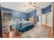 Serene main bedroom with a ceiling fan, hardwood floors, and ensuite bathroom access at 16808 Woburn Ln, Lutz, FL 33549