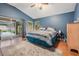 Comfortable main bedroom with outdoor access, ceiling fan, and ample natural light at 16808 Woburn Ln, Lutz, FL 33549