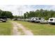 RV and boat parking area with gravel drive and surrounded by trees at 16808 Woburn Ln, Lutz, FL 33549