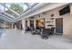 Outdoor patio with comfortable seating, ceiling fans, and decorative wall hangings at 16808 Woburn Ln, Lutz, FL 33549