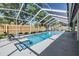 A screened-in pool with lounge chairs by the edge, offering a relaxing outdoor space at 16808 Woburn Ln, Lutz, FL 33549