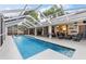 Beautiful screened-in pool area with ample seating at 16808 Woburn Ln, Lutz, FL 33549