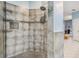 Updated shower featuring gray tiling, a built-in shelf, and modern fixtures at 16808 Woburn Ln, Lutz, FL 33549