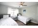 Bright bedroom featuring two twin beds, a ceiling fan, and a window with natural light at 17035 Gulf Blvd # 205, North Redington Beach, FL 33708