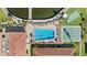 Aerial view of a community pool, shuffleboard, beautiful landscaping and common areas in a well-maintained residential area at 19029 Us Highway 19 N # 27E, Clearwater, FL 33764