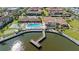 Aerial view of a community pool and pond surrounded by lush landscaping and beautiful buildings in a residential area at 19029 Us Highway 19 N # 27E, Clearwater, FL 33764