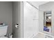 Bathroom featuring a shower with sliding glass doors and a toilet at 19029 Us Highway 19 N # 27E, Clearwater, FL 33764