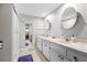 Bathroom showcasing double sinks and a shower with sliding glass doors at 19029 Us Highway 19 N # 27E, Clearwater, FL 33764