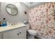 Cozy bathroom features nautical-themed decor, vanity, and a round mirror, offering a charming space at 19029 Us Highway 19 N # 27E, Clearwater, FL 33764