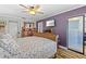 Comfortable bedroom featuring a ceiling fan, stylish decor, and a wall-mounted television at 19029 Us Highway 19 N # 27E, Clearwater, FL 33764