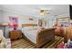 Inviting bedroom showcasing wood floors, ceiling fan, and coordinating furniture at 19029 Us Highway 19 N # 27E, Clearwater, FL 33764