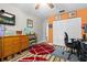 Bright bedroom features a wood dresser, round red rug, and playful decor for a space at 19029 Us Highway 19 N # 27E, Clearwater, FL 33764