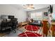 Bedroom with a ceiling fan, red rugs, and a couch near the window at 19029 Us Highway 19 N # 27E, Clearwater, FL 33764