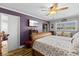 Cozy bedroom displaying wood floors, a ceiling fan, and a sliding glass door at 19029 Us Highway 19 N # 27E, Clearwater, FL 33764