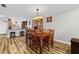 Warm dining room showcases hardwood floors, elegant lighting, and a seamless transition to the modern kitchen at 19029 Us Highway 19 N # 27E, Clearwater, FL 33764