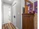 Neutral hallway showcasing wood floors, a closet, and access to other rooms at 19029 Us Highway 19 N # 27E, Clearwater, FL 33764