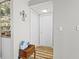 Hallway leading to closet with wooden floors and a small accent table at 19029 Us Highway 19 N # 27E, Clearwater, FL 33764