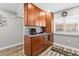 Kitchen area featuring wooden cabinetry with a microwave and coffee station and a window at 19029 Us Highway 19 N # 27E, Clearwater, FL 33764