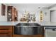 Close-up of a deep stainless steel sink in kitchen with wooden cabinetry at 19029 Us Highway 19 N # 27E, Clearwater, FL 33764