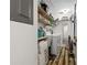 Functional laundry room with a washing machine, dryer, and storage shelves at 19029 Us Highway 19 N # 27E, Clearwater, FL 33764