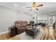 Comfortable living room featuring leather seating, a ceiling fan, and views into the bright sunroom at 19029 Us Highway 19 N # 27E, Clearwater, FL 33764