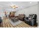 Inviting living room features leather seating, wood floors, and an open layout to the dining and kitchen areas at 19029 Us Highway 19 N # 27E, Clearwater, FL 33764