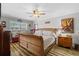 Cozy main bedroom features a wood bed, ceiling fan, and ample natural light at 19029 Us Highway 19 N # 27E, Clearwater, FL 33764