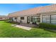 Charming patio with brick pavers, overlooking a meticulously maintained lawn and the building's exterior at 19029 Us Highway 19 N # 27E, Clearwater, FL 33764