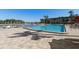 Community pool, featuring ample seating, clear water, and a picturesque waterfront backdrop at 19029 Us Highway 19 N # 27E, Clearwater, FL 33764