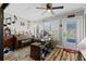 Bright sun room featuring a piano and desk with views of the yard at 19029 Us Highway 19 N # 27E, Clearwater, FL 33764