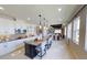 Open-concept kitchen boasts white cabinetry, granite countertops, a dark island, and a seamless flow to the dining area at 1904 146Th E Ter, Parrish, FL 34219