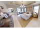 Serene main bedroom showcases a tray ceiling, ensuite bathroom, and elegant decor for a relaxing retreat at 1904 146Th E Ter, Parrish, FL 34219