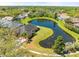 Picturesque aerial view of a home backing onto a tranquil pond surrounded by lush greenery at 19230 Wind Dancer St, Lutz, FL 33558
